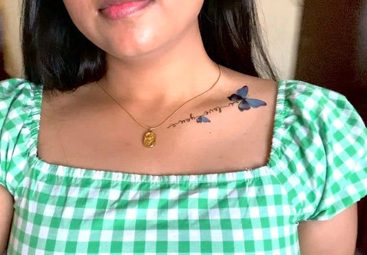 Butterfly collarbone tattoo